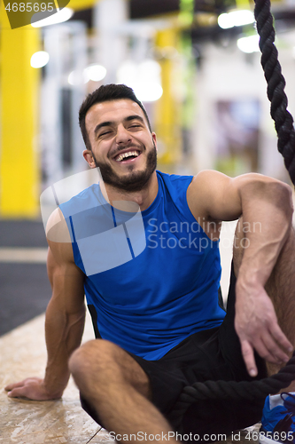 Image of man relaxing before rope climbing