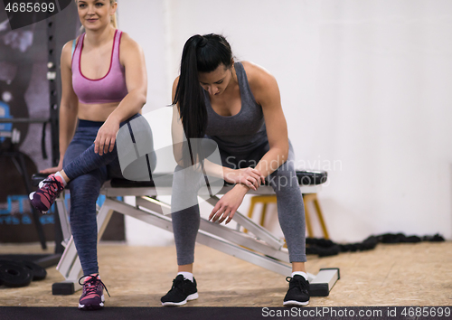 Image of young athletes women sitting and relaxing