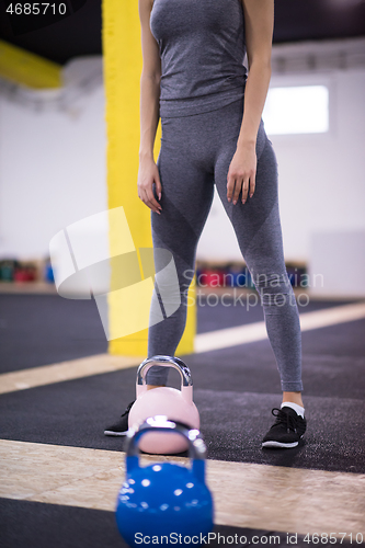 Image of woman exercise with fitness kettlebell