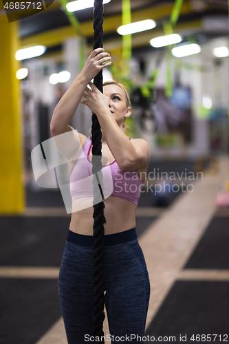 Image of woman doing rope climbing