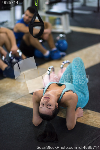 Image of young athlete woman lying on the floor and relaxing
