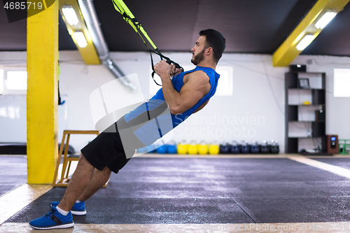 Image of man working out pull ups with gymnastic rings