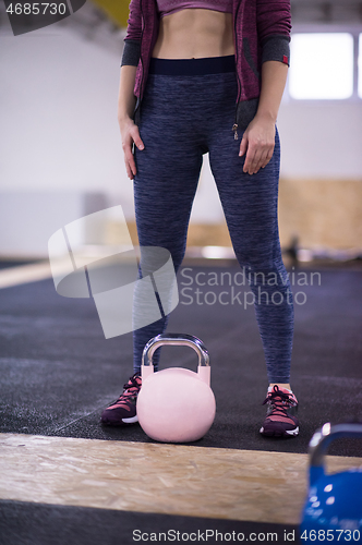 Image of woman exercise with fitness kettlebell