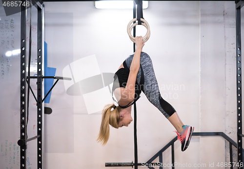 Image of woman working out on gymnastic rings