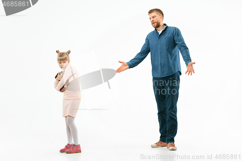 Image of Angry father scolding his daughter at home