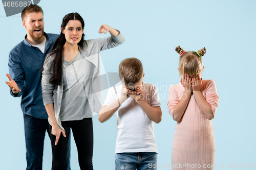 Image of Angry parents scolding their children at home