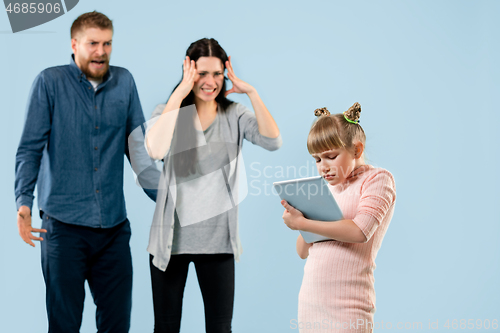 Image of Angry parents scolding their daughter at home