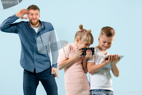 Image of Angry father scolding his son in living room at home