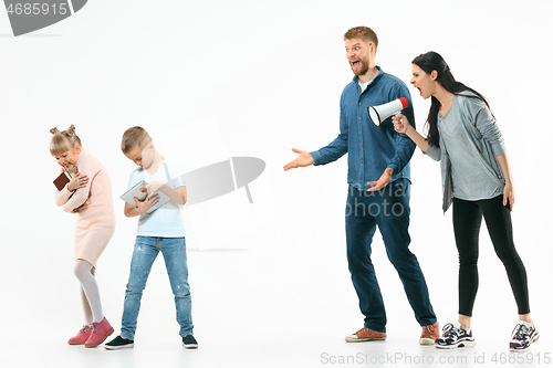 Image of Angry parents scolding their children at home