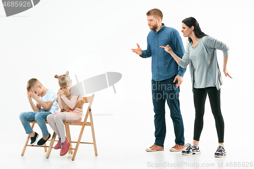 Image of Angry parents scolding their children at home