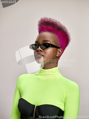 Image of Close-up indoor portrait of lovely girl with colorful hair. Studio shot of graceful young woman with long haircut