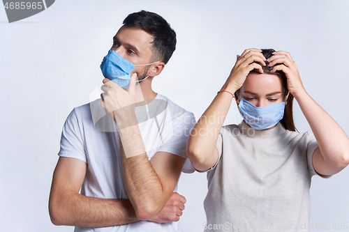 Image of Young couple wearing medicine masks