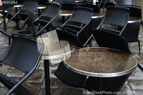 Image of empty coffee tables in the rain 