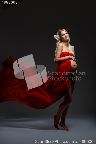 Image of Pregnant girl in red dress