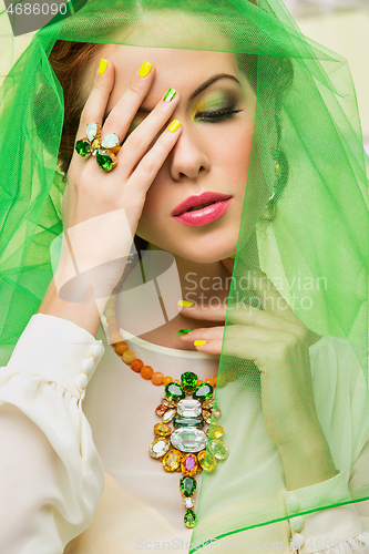 Image of beautiful girl in green veil