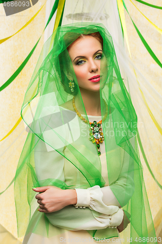 Image of beautiful girl in green veil