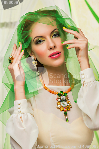Image of beautiful girl in green veil