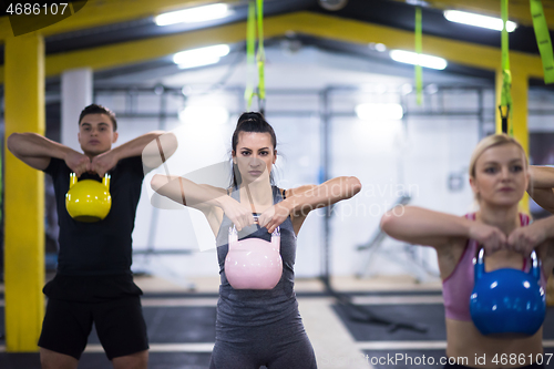 Image of athletes doing exercises with kettlebells