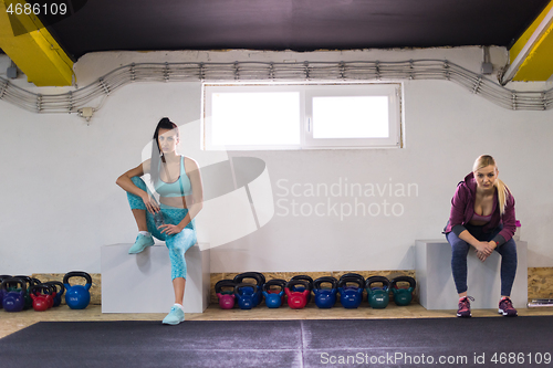Image of young athletes women sitting and relaxing