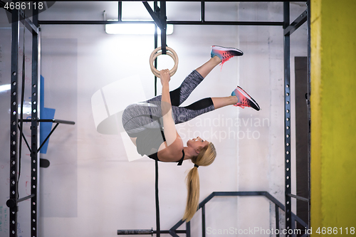 Image of woman working out on gymnastic rings