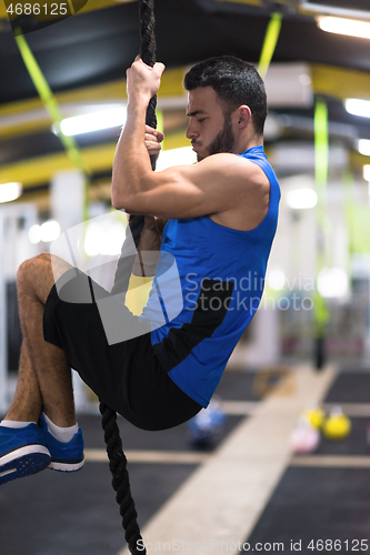 Image of man doing rope climbing