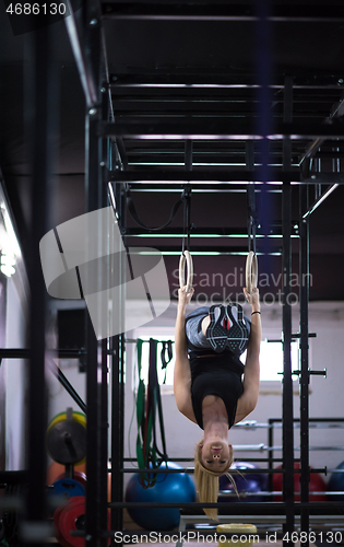 Image of woman working out on gymnastic rings