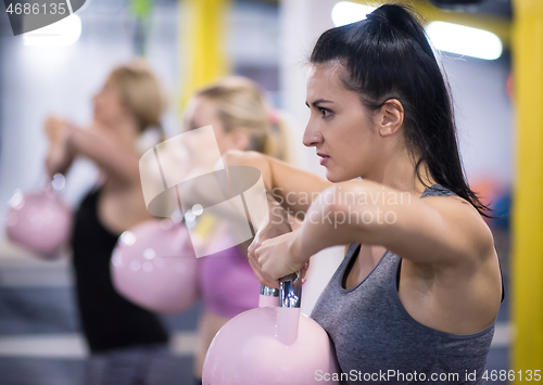 Image of athletes doing exercises with kettlebells