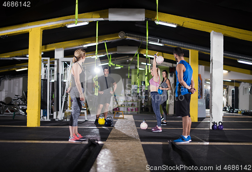 Image of athletes doing exercises with kettlebells