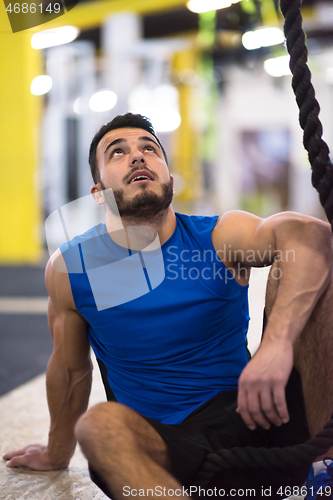 Image of man relaxing before rope climbing