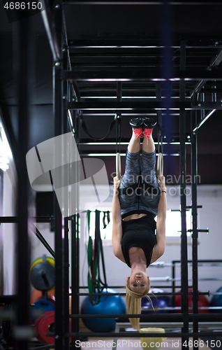 Image of woman working out on gymnastic rings