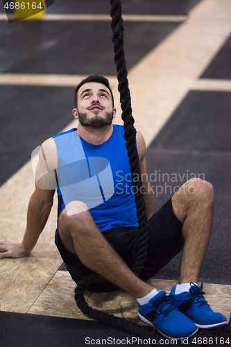 Image of man relaxing before rope climbing