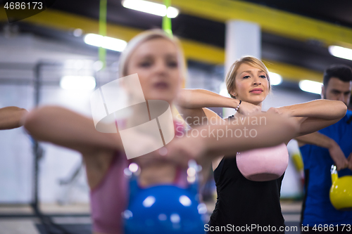 Image of athletes doing exercises with kettlebells