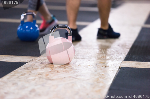 Image of athletes doing exercises with kettlebells