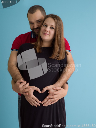 Image of pregnant couple  isolated over blue background