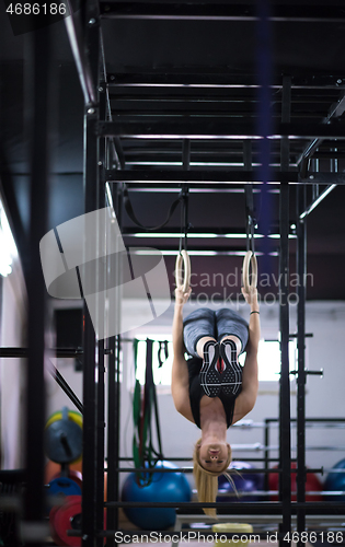 Image of woman working out on gymnastic rings