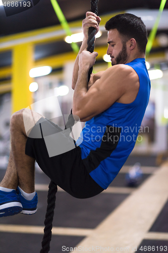 Image of man doing rope climbing