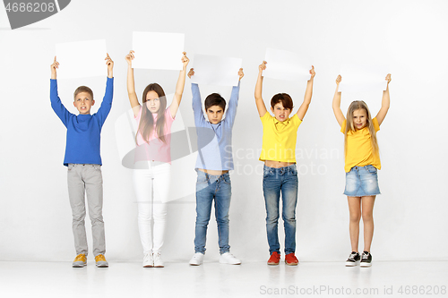 Image of Group of children with a white banners isolated in white