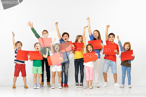 Image of Group of children with a red banners isolated in white