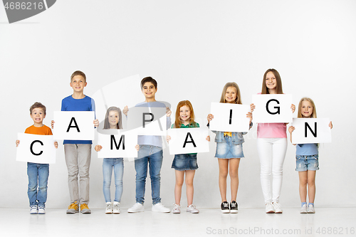 Image of Campaign. Group of children with a banners isolated in white