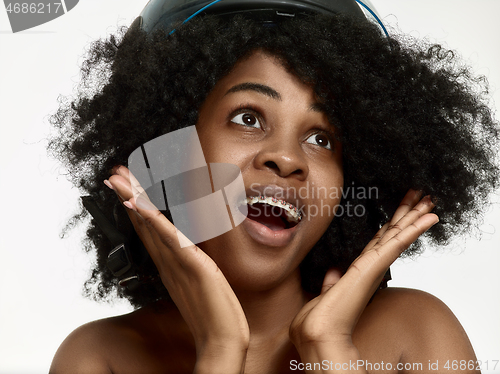 Image of Portrait of a young black woman smiling with braces