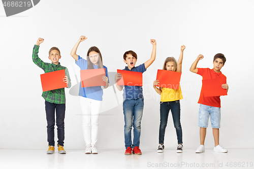 Image of Group of children with red banners isolated in white