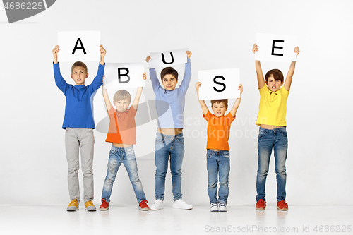 Image of Abuse. Group of children with a banners isolated in white