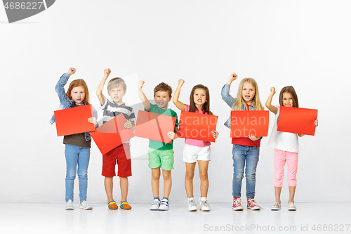 Image of Group of children with red banners isolated in white