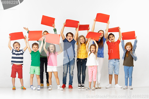 Image of Group of children with a red banners isolated in white