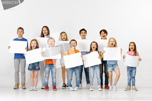 Image of Group of children with a white banners isolated in white