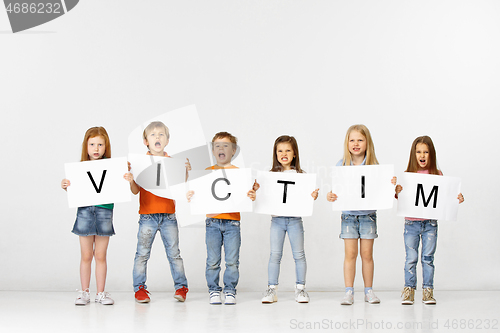 Image of Victim. Group of children with a banners isolated in white