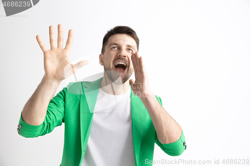 Image of Young casual man shouting. Shout.