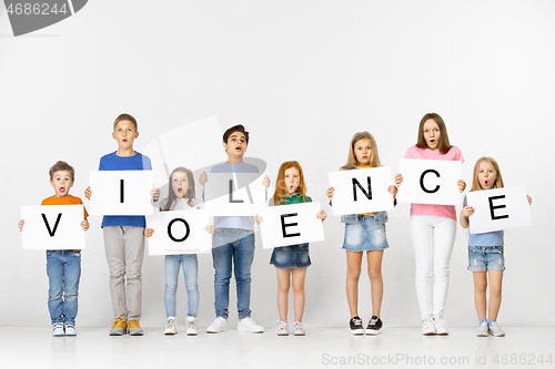 Image of Violence. Group of children with a banners isolated in white