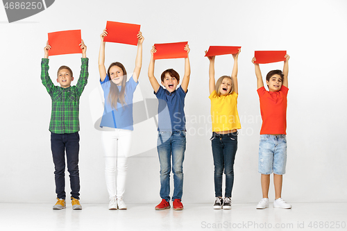 Image of Group of children with red banners isolated in white