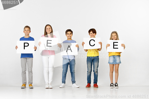 Image of Peace. Group of children with a banners isolated in white